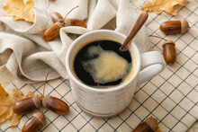 Cup Of Coffee With Acorns And Autumn Leaves On Table