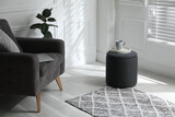 Fototapeta  - Tray with cup on stylish ottoman in room. Home design