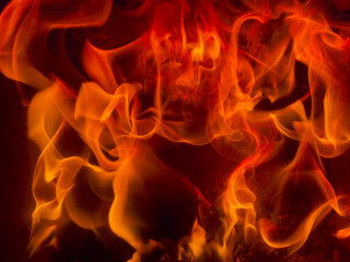 Burning powerblaze fire flame texture background. Fire creates infinity shapes when it burns. The red from the flame and the black backgroud creates interesting textures. Flames from hell.