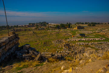 Wall Mural - PAMUKKALE, TURKEY: Ruins of the ruined city of Hierapolis in Pamukkale on a sunny day.