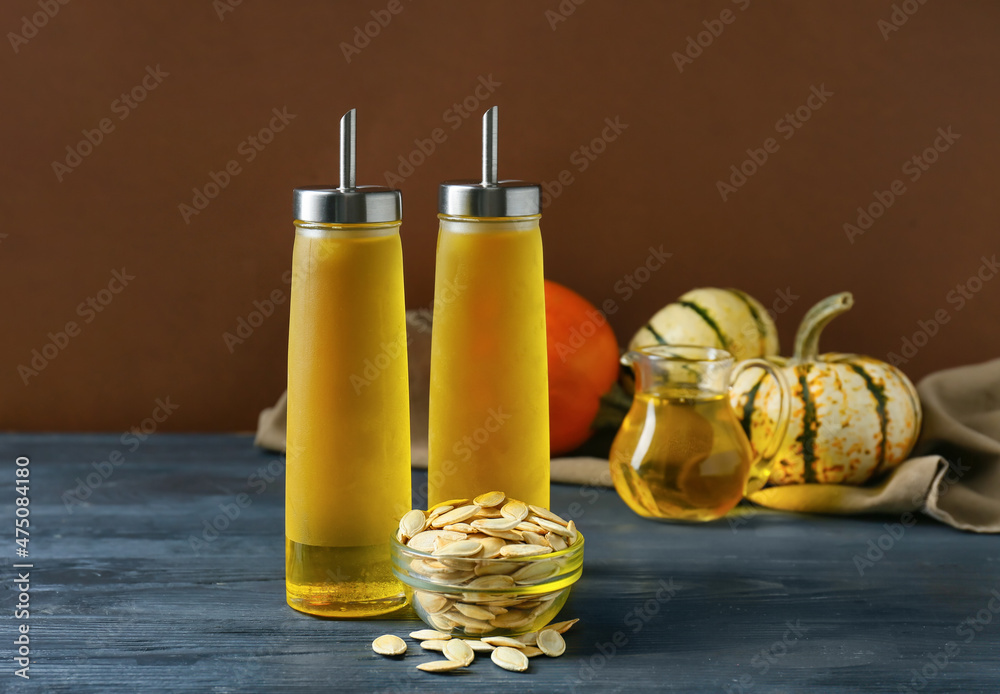 Bottles with pumpkin seed oil on table