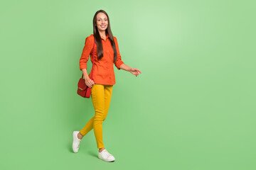 Wall Mural - Full size profile side photo of young adorable woman walking free-time isolated over green color background