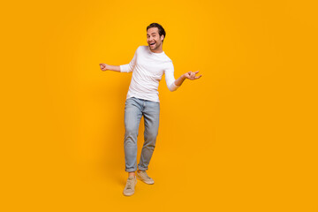 Sticker - Full size photo of impressed brunet millennial guy go wear shirt jeans shoes isolated on yellow background