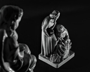 Grayscale image of a Holy Family and angel watching over them