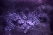 Purple Smoke On Black Ink Background, Colorful Fog, Abstract Swirling Purple Ocean Sea, Acrylic Paint Pigment Underwater