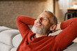 © InsideCreativeHouse - Relaxed caucasian mature middle-aged man resting with eyes closed at home on the couch sofa after hard-working day, chilling on lockdown