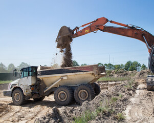 Wall Mural - Large gray articulated dumper at a construction site during loading and transporting soil. preparation of the construction site, earthwork