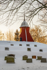 Wall Mural - Belfry on a hill at a graveyard a snowy winter day