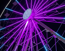Purple Illuminated Part Of A Ferris Wheel At Night