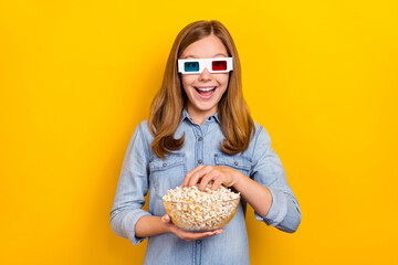 Poster - Photo of funky small blond girl eat pop corn wear eyewear denim shirt isolated on bright yellow color background