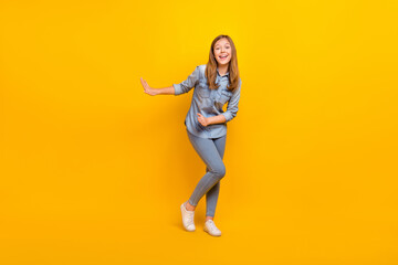 Sticker - Full length photo of sweet teenager blond girl dance wear jeans shirt shoes isolated on yellow color background