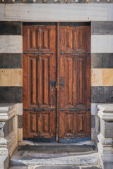 old wooden door in historical stone building. ulucami. grand mosque, adana, turkey.