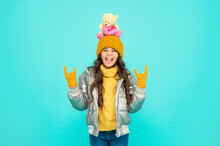 Childhood. Teen Girl Hold Toy Bear. Child Wearing Warm Clothes On Blue Background.