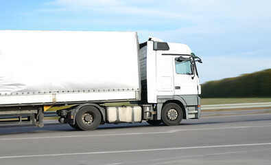 White truck driving on the highway on a sunny day