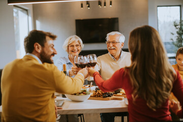 Wall Mural - Happy family having dinner with red wine at home