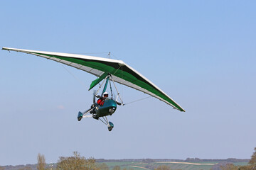 Poster - Ultralight airplane flying in a blue sky	