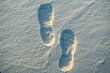 Footprint on the texture of snow at sunset