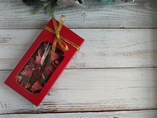 Chocolate with strawberries in a festive package. Delicious gift. Handmade chocolate.	
