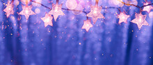 String Lights In The Shape Of Stars With Bokeh Lights On A Shiny Background In The Colors Of 2022