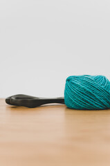 Poster - decorative rustic cyan yarn ball and scissors on a wooden tabletop