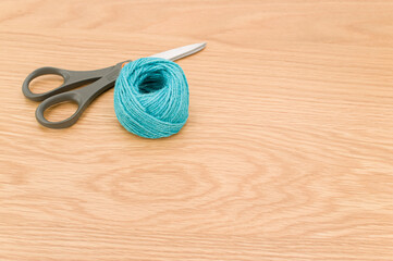 Canvas Print - decorative rustic cyan yarn ball and scissors on a wooden tabletop