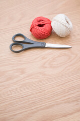 Sticker - decorative rustic yarn ball and scissors on a wooden tabletop with copy space