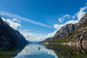 Wall Mural - Person kayaking on the Lysefjorden under the sunlight in Norway