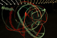 Digital Render Of Abstract Green Red Swirls And Curves On A Black Background