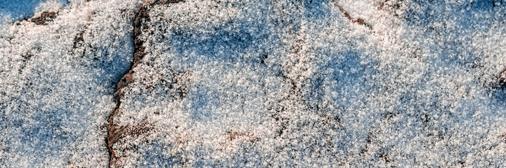 Wall Mural - Beautiful winter background with snowy ground. Natural snow texture.