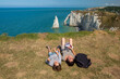 Mother and her son smiling in front of the cliffs of Etretat