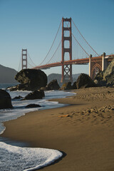 Poster - Sandy beach and the famous Golden bridge in the background on a sunny day