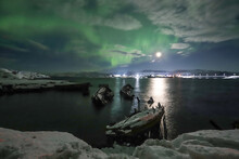 Northern Lights Over The Sea. Night Landscape. Northern Lights Over Boats