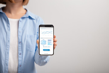 Aufkleber - Unrecognizable woman holding smartphone with graphs and diagrams on screen
