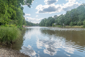 Poster - Aura river between trees at with clouds in summer day in Finland.