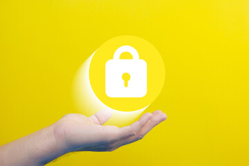 Poster - Hand hold a padlock to protect business and information data. Innovation technology develops clever solutions to protect against digital attacks.