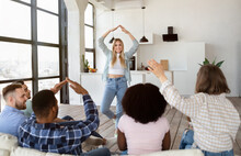 Group Of Cheerful Diverse Friends Playing Charades Guessing Game At Home