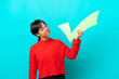 © luismolinero - Young woman isolated on blue background holding a check icon with happy expression