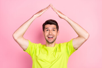 Sticker - Photo portrait smiling man wearing bright t-shirt feeling safe new insurance isolated pastel pink color background