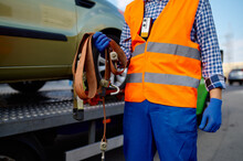 Male Tow Truck Assistant Holding Fastening Belts