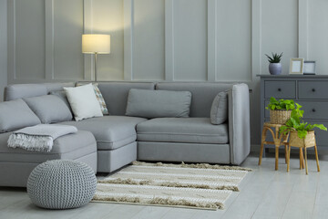 Sticker - stylish living room interior with comfortable grey sofa and plants