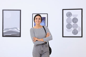 Wall Mural - Happy young woman at exhibition in art gallery