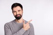 © Tetiana - Photo of young handsome guy indicate finger empty space ad promotion way isolated over grey color background
