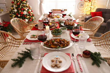 Poster - Festive dinner with delicious food and wine on table indoors. Christmas Eve celebration