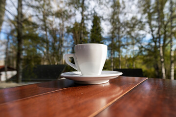 Wall Mural - White cup of coffee with glass of water. White cup of double espresso coffee wit sugar and milk.