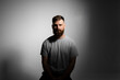 © Volodymyr_sh - Close-up portrait of a handsome a brunette brutal bearded man in a grey t-shirt. Stylish and handsome man with a beard.