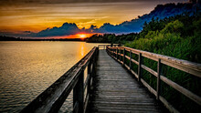 Mesmerizing Shot Of A Seascape Under The Sunset From A Wooden Bridge