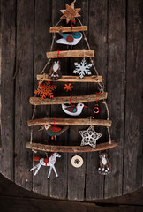 Wall Mural - hanging on the wall alternative wooden christmas tree with wooden decorations.christmas and new year background