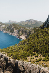 Canvas Print - Vertical shot of the cliffs and the blue sea. Mirador Es Colomer, Spain.