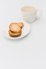 Sticker - delicious hot vegan Cappuccino with foam in a white cup with crispy biscuits on a white tabletop