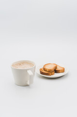 Sticker - delicious hot vegan Cappuccino with foam in a white cup with crispy biscuits on a white tabletop